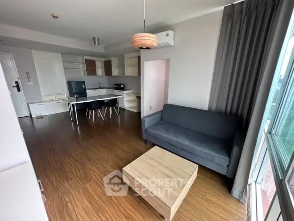 Modern open-plan living room with sleek kitchen and stylish furnishings.