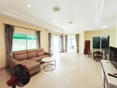 Spacious living room with modern furniture and large windows for natural light.