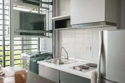 Modern kitchen with sleek appliances and large window for natural light