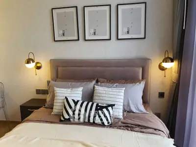 Stylish bedroom with modern decor and cozy bedding in a contemporary apartment.