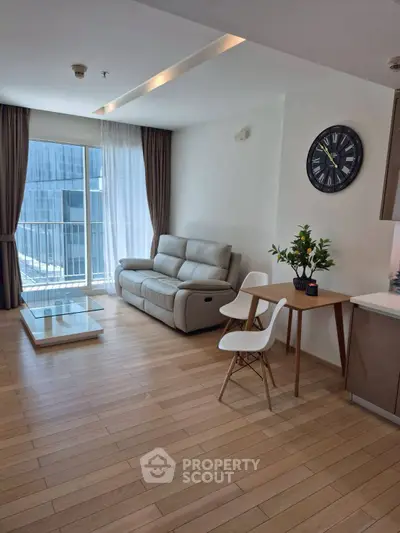 Modern living room with sleek furniture and large window view