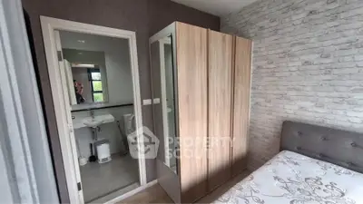 Cozy bedroom with wardrobe and en-suite bathroom in modern apartment