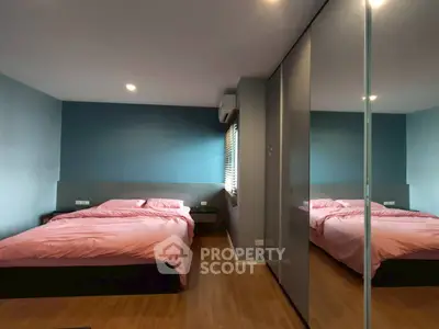 Modern bedroom with mirrored closet and stylish decor