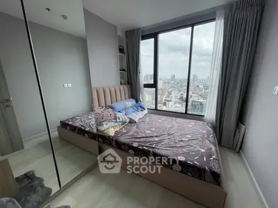 Modern bedroom with city view, featuring large window and stylish decor in high-rise apartment.