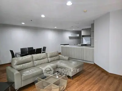 Spacious modern living room with open kitchen and sleek furniture