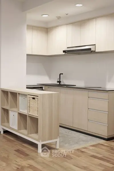 Modern kitchen with sleek cabinetry and open layout in a stylish apartment.