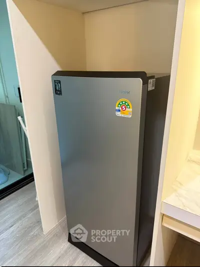 Modern kitchen with sleek refrigerator in compact space