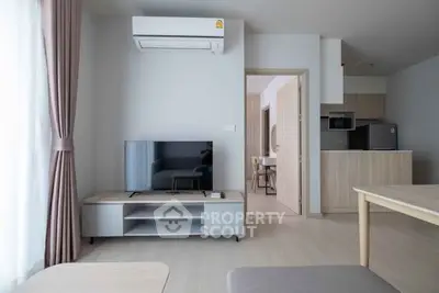 Modern living room with sleek furniture and open kitchen layout