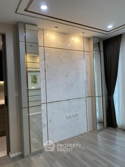 Luxurious modern interior with marble accent wall and elegant lighting