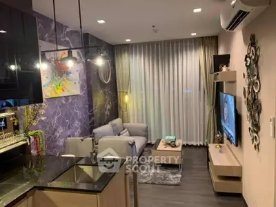 Modern living room with stylish decor and open kitchen layout, featuring cozy seating and ambient lighting.