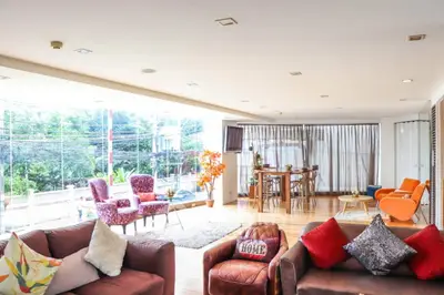 Spacious living room with modern decor and large windows offering abundant natural light.