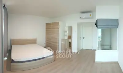 Spacious bedroom with modern wooden furniture and large window