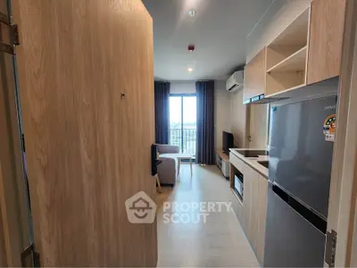 Modern apartment interior with open kitchen and living area, featuring sleek appliances and a bright, airy atmosphere.