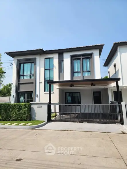Modern two-story house with sleek design and large windows