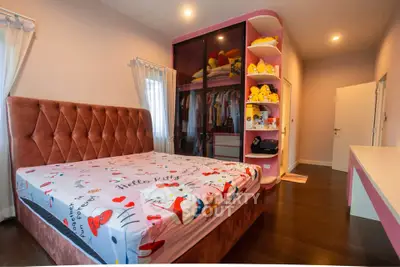 Charming bedroom with plush bed and colorful decor, perfect for a cozy and inviting atmosphere.