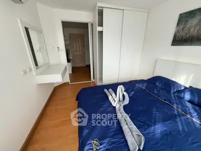 Modern bedroom with sleek design, featuring a cozy bed and built-in wardrobe, perfect for urban living.