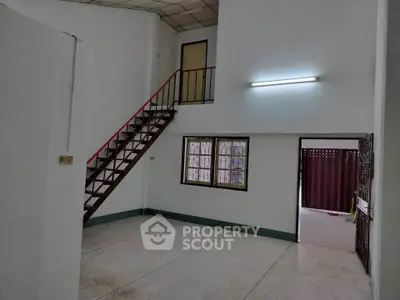 Spacious interior with staircase and natural light, ideal for modern living.