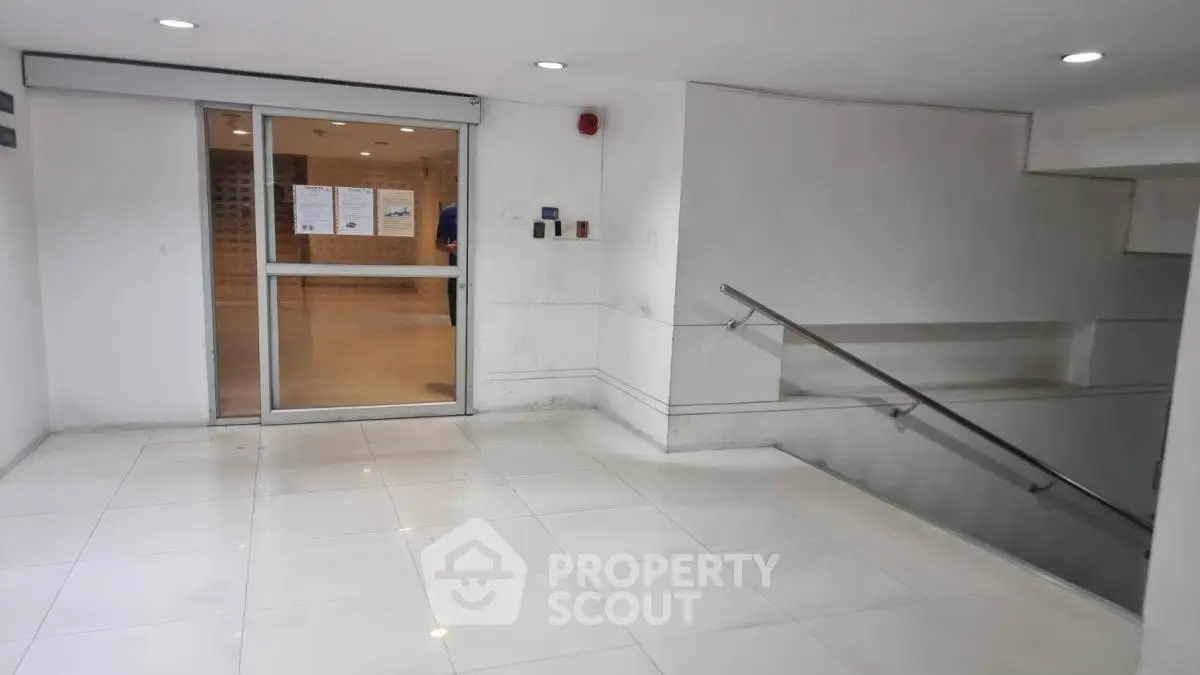 Spacious building entrance with modern design and sleek tiled flooring