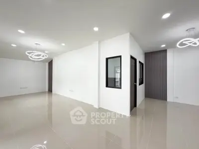 Spacious modern living room with elegant lighting and glossy tiled floors
