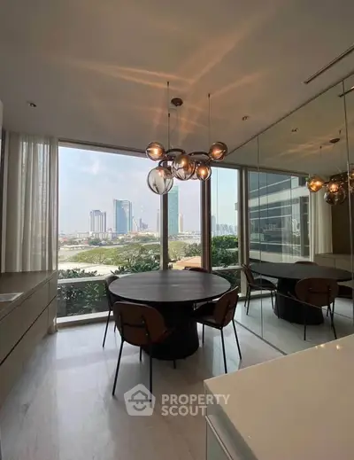 Modern dining area with large window offering stunning city view and stylish lighting fixture.