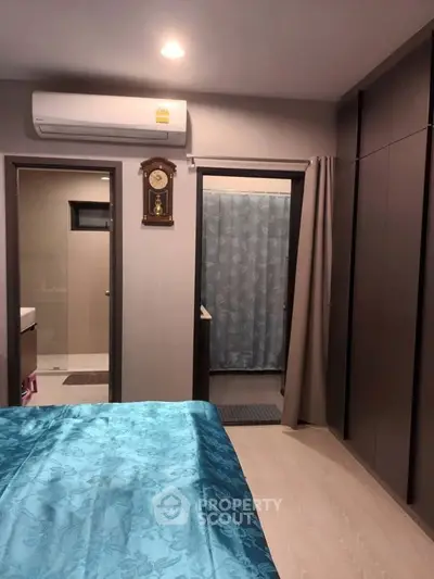 Cozy bedroom with ensuite bathroom and modern air conditioning unit