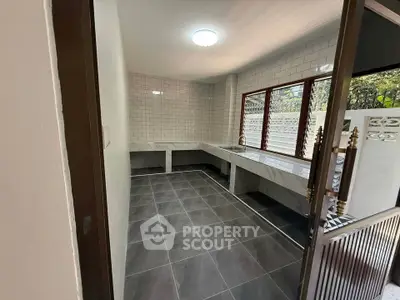 Spacious kitchen with sleek tile flooring and ample counter space