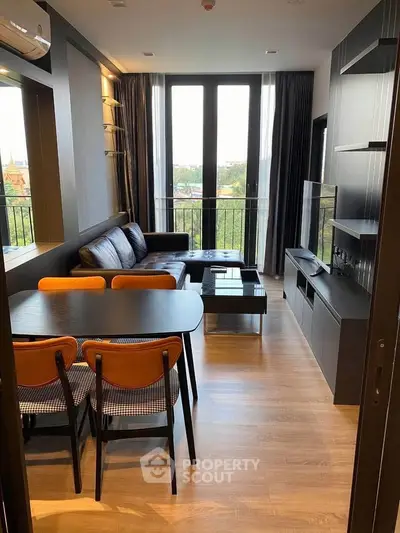 Modern living room with stylish furniture and large windows offering a scenic view.