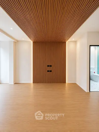 Modern minimalist living room with wooden accents and recessed lighting