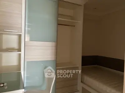 Compact bedroom with built-in wardrobe and cozy bed, ideal for efficient living space.
