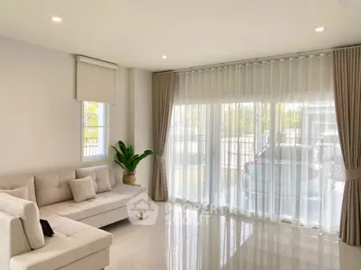 Bright living room with large windows and modern decor