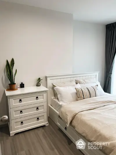 Cozy bedroom with elegant white furniture and natural light