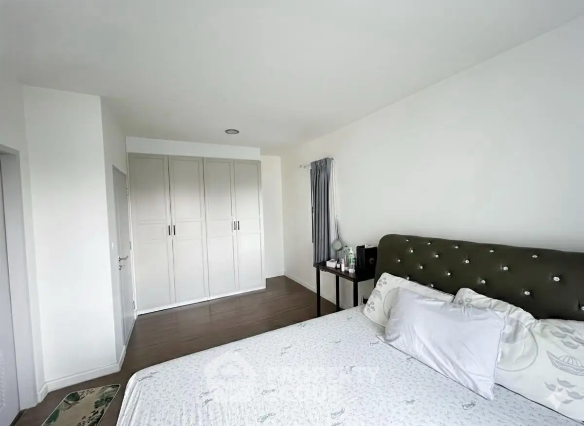 Spacious bedroom with elegant decor and ample storage space