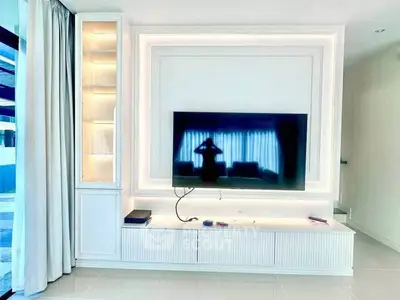 Modern living room with sleek TV setup and elegant lighting