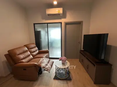 Cozy living room with leather sofa and modern TV setup