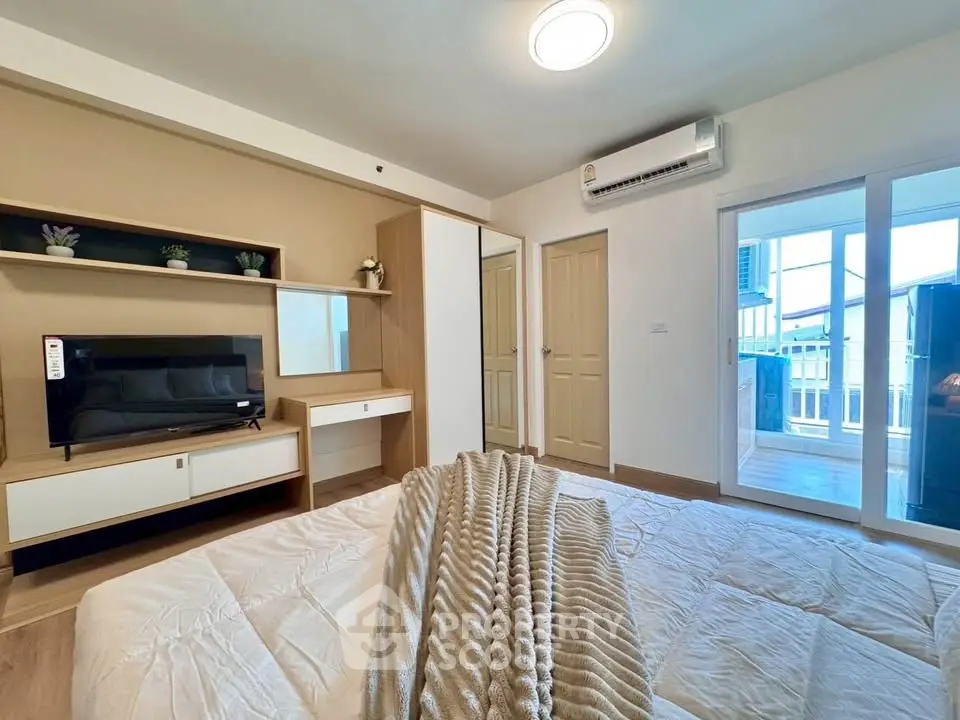 Modern bedroom with balcony access and stylish decor in a contemporary apartment.