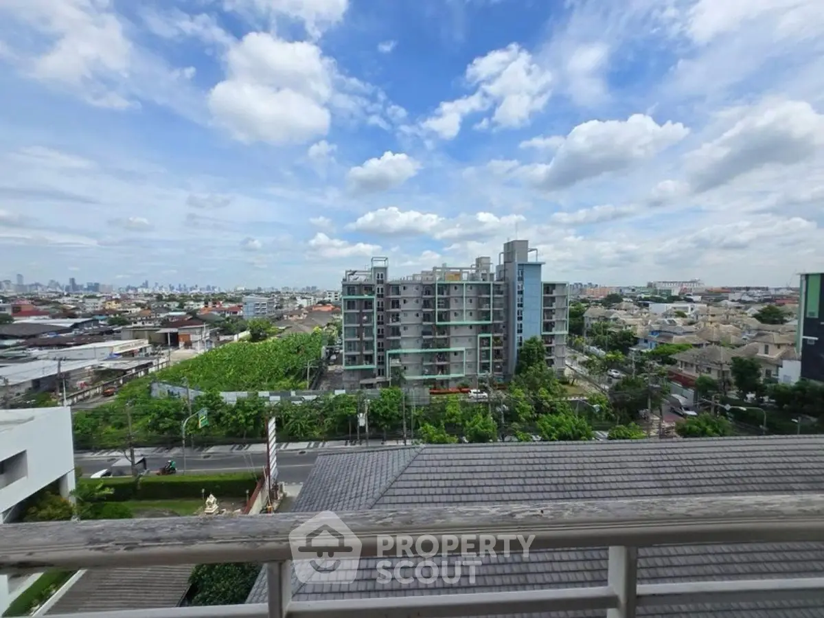 Stunning cityscape view from a high-rise balcony showcasing urban living and greenery.