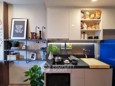 Modern kitchen with sleek cabinets and open shelving, featuring a stylish backsplash and contemporary decor.