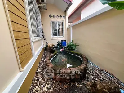 Charming garden with koi pond in cozy residential backyard