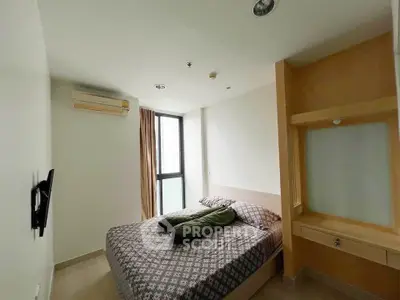 Cozy bedroom with modern design and natural light in a stylish apartment.