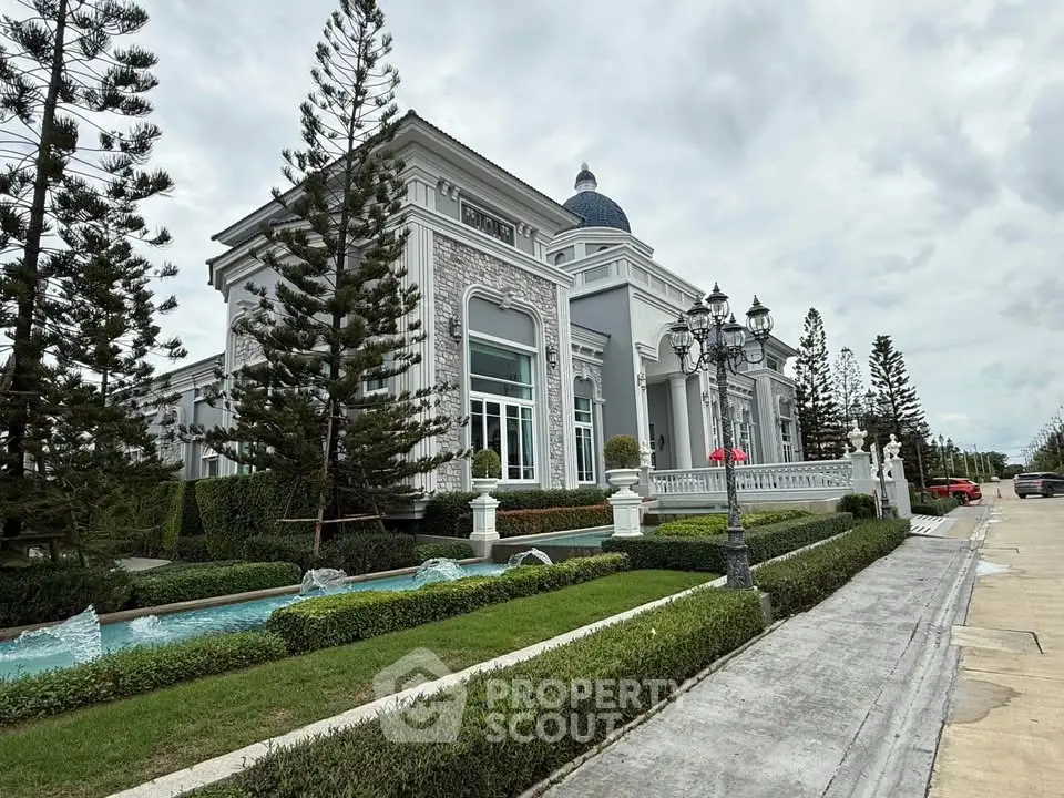 Luxurious mansion with elegant architecture and manicured gardens, showcasing grandeur and sophistication.