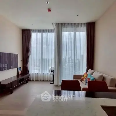 Spacious modern living room with large windows and city view