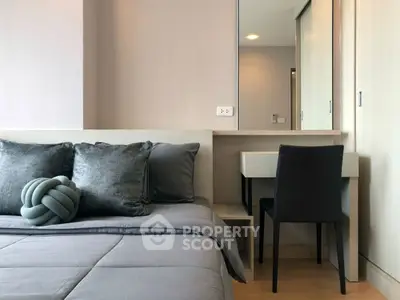 Modern bedroom with stylish decor and cozy bedding in a contemporary apartment.