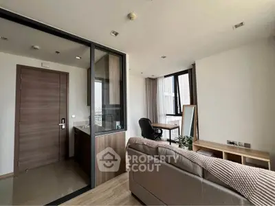 Modern living room with sleek design and large windows for natural light.