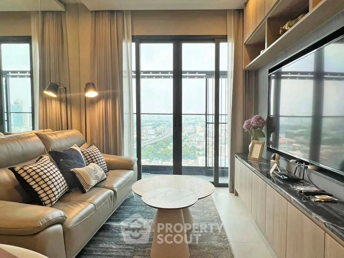Luxurious living room with stunning city view, modern decor, and elegant furnishings in high-rise apartment.