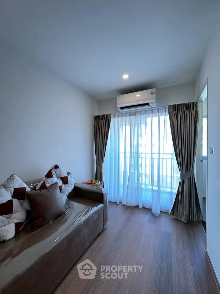 Modern living room with cozy sofa and large window for natural light