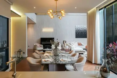 Luxurious open-plan living and dining area with elegant decor and natural light.