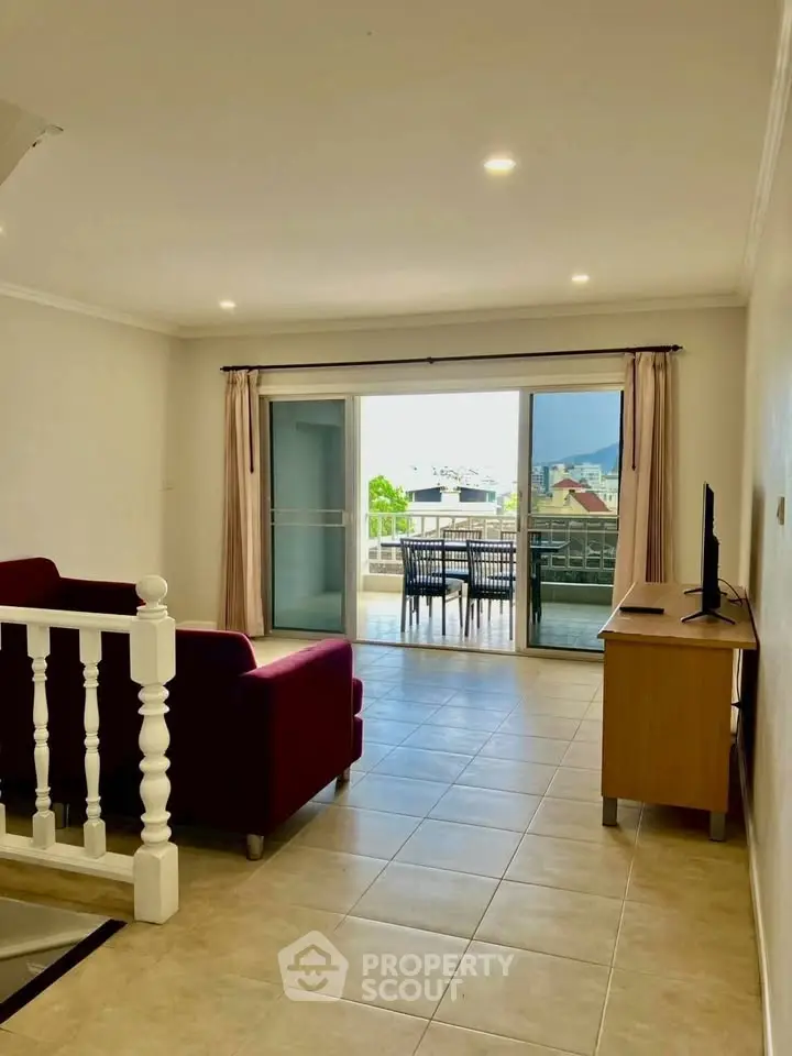 Spacious living room with balcony view and modern furniture