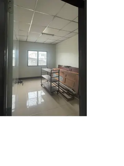 Spacious storage room with tiled floor and ample natural light.