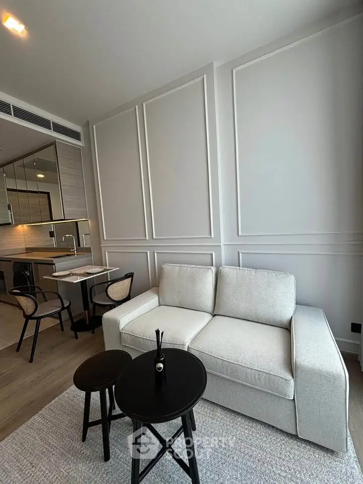 Modern living room with elegant decor and cozy seating in a stylish apartment.
