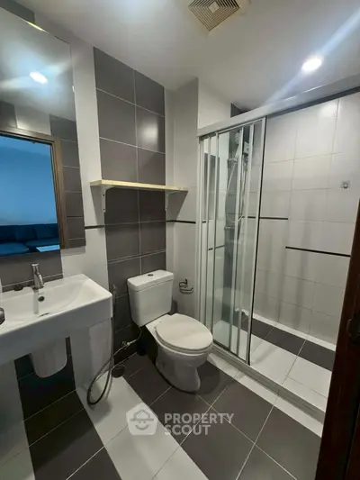 Modern bathroom with sleek shower enclosure and stylish tiles